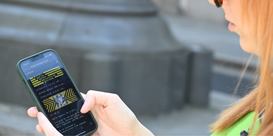 Player using phone as a spy gadget to solve puzzles in Brighton